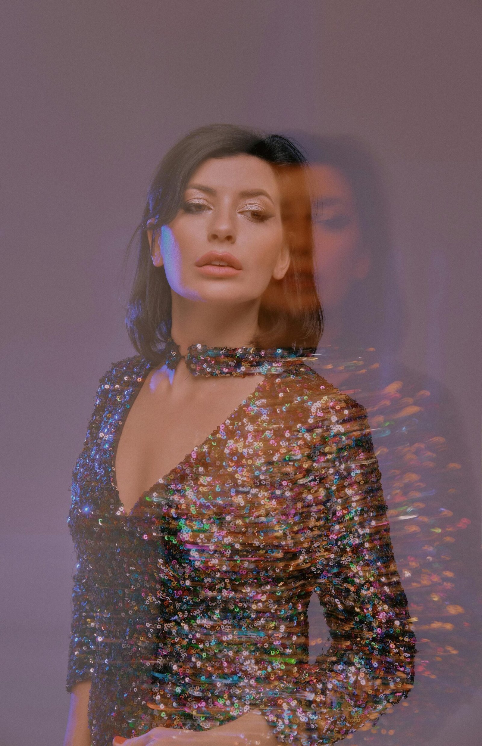 Model in blurry photo and glittery dress