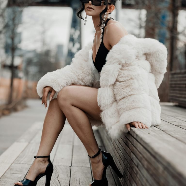 Woman Model in fur coat posing in downtown
